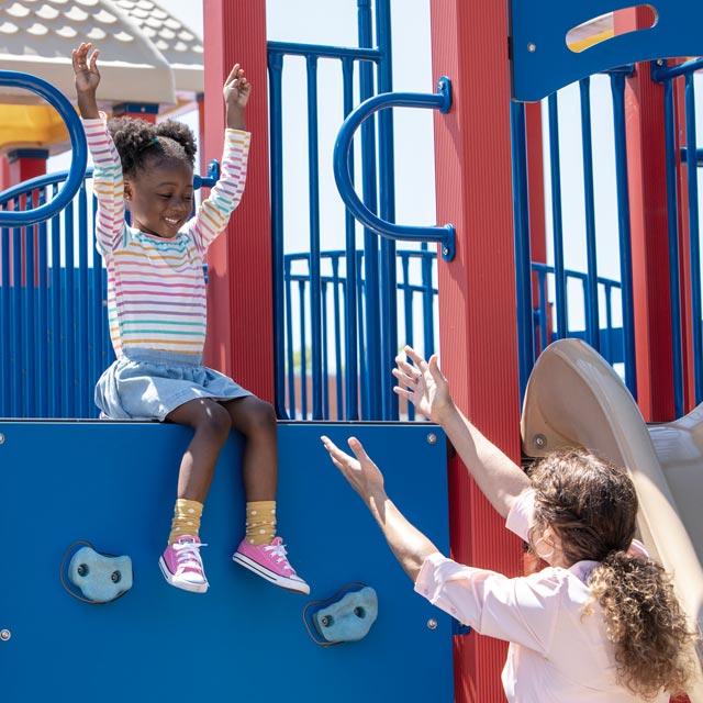 Common Question-caregiver helps child in playground