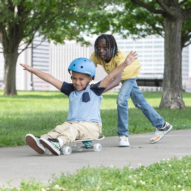 Common Questions-Boy helps another boy skateboard