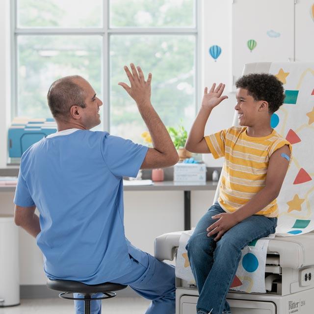 Common Questions-doctor and young boy high five