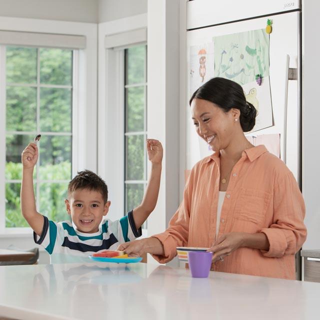 Common Questions-boy at kitchen table with mother