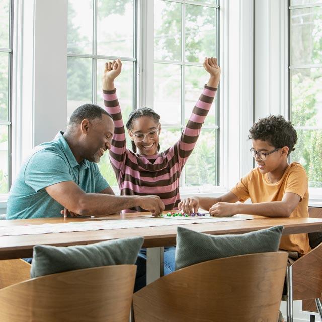 Common Questions-girl celebrates while playing board game