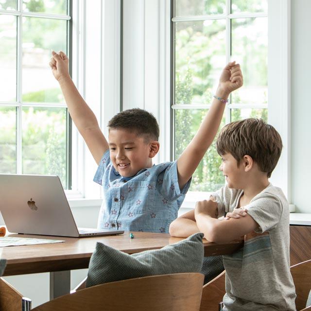 Common Questions-boy with laptop at school with classmate