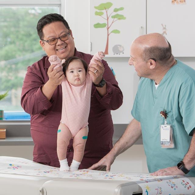 Common Questions-baby girl with doctor and parent